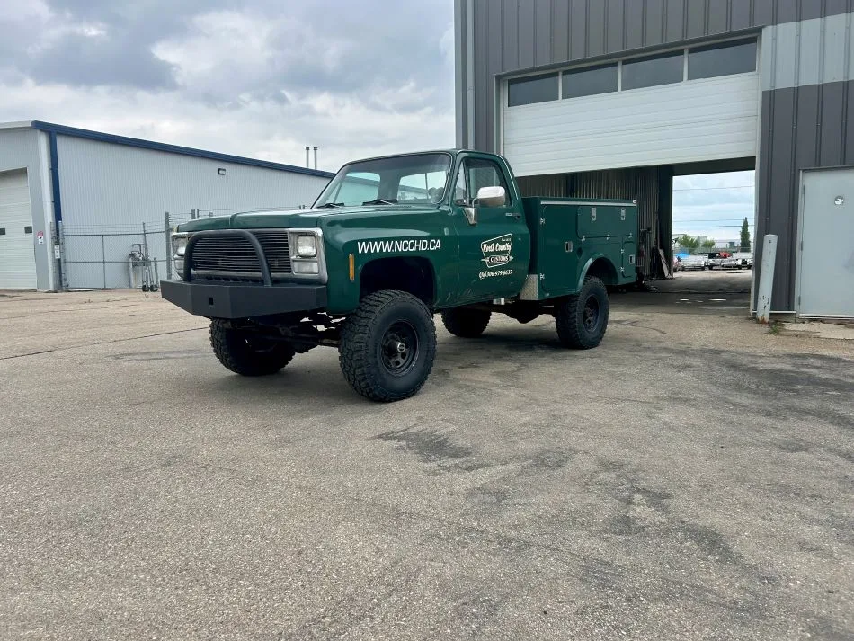 Green lifted Chevrolet service body 4x4 shop truck by North Country Customs